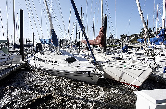 Sailboats in the Santa Cruz Harbor crash against each other Friday in Santa Cruz, Calif. A tsunami triggered by the massive earthquake in Japan rushed onto California's coast Friday, causing powerful surges that destroyed boat docks as beach-area residents throughout the state evacuated to higher ground.