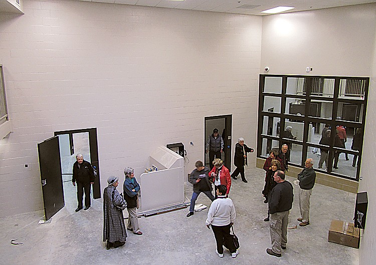 Volunteers with the Jefferson City Area Chamber of Commerce take a look at the female prisoner holding area during a tour of the new Cole County Jail.