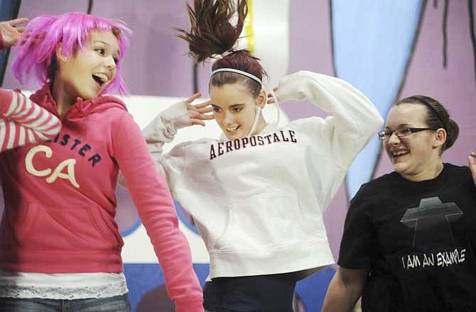 Ashton Bernskoetter, 14, left, Taylor Engelbrecht, 13, center, and Jennifer Maier, 14, dance with other seventh- and eighth-graders during the Immanuel Lutheran school talent show Friday in Honey Creek. 