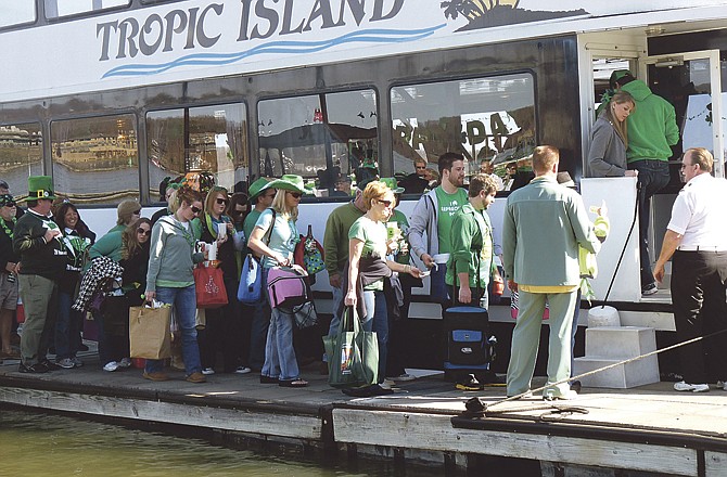The Tropic Island cruise boat docked at Ozark Bar-B-Que Saturday morning to pick up passengers participating in the water parade. More than 60 people boarded the boat to enjoy a day on the Lake of the Ozarks and the waterfront restaurants. 