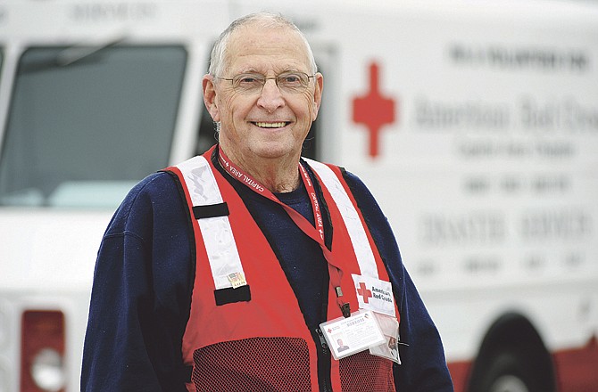 Longtime Red Cross volunteer Carl Nappier poses outside a van he's refurbished and uses to promote the services offered by the organization.