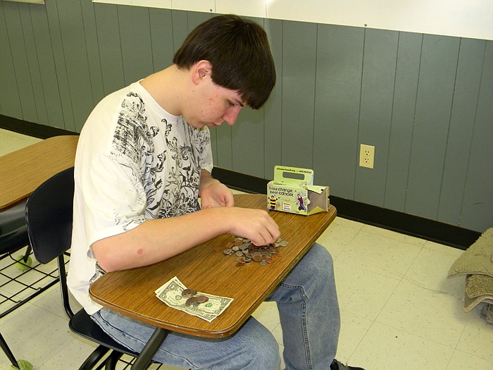Russellville eighth grader Wyatt Bunselmeyer counts pennies for the Pennies for Patients fundraiser held at Russellville Middle School.