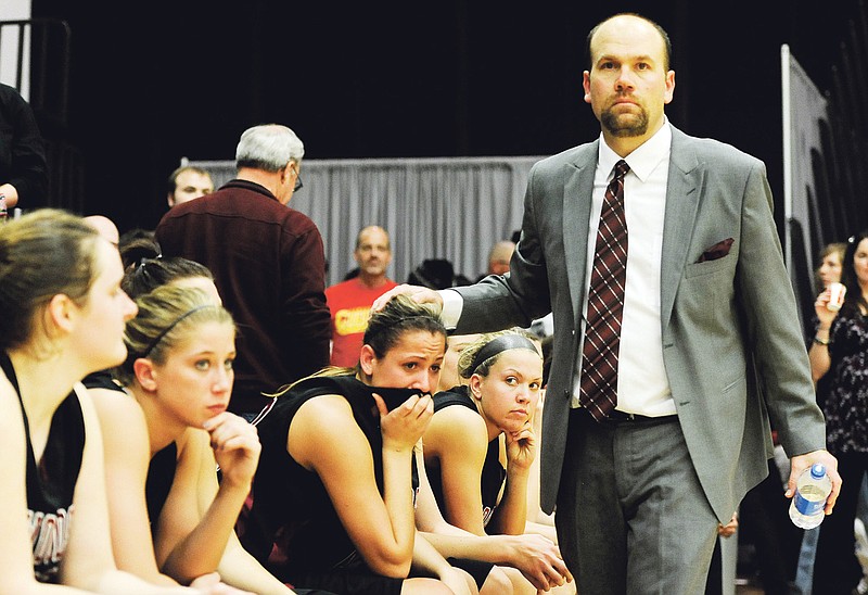 Dak Dillon/FULTON SUN photo: William Woods head coach Dan Chapla consoles junior forward Megan Aubuchon in the final minutes of the No. 21 Lady Owls' 70-56 loss to No. 11 Columbia College in the title game of the AMC postseason tournament March 9 in Columbia. Chapla and the Lady Owls will be looking to make a first-round breakthrough at the NAIA Division I women's national tournament tonight (9:45 tipoff) when they face No. 9 Biola (Calif.) at Oman Arena in Jackson, Tenn.