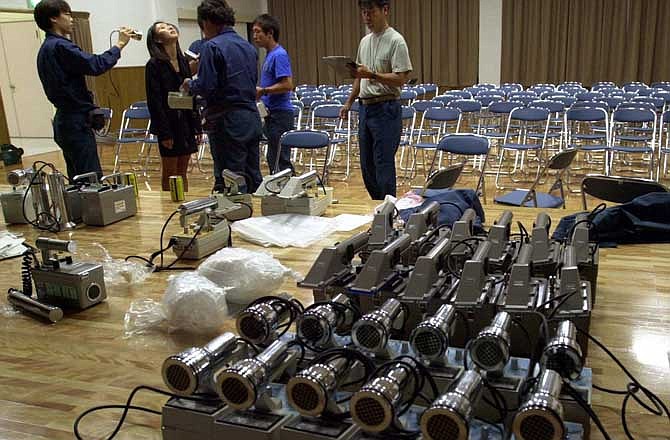 In this Oct. 1, 1999 file photo, radiation detection devices are prepared after a radiation leak at a uranium processing facility in Tokaimura, 110 kilometers (70 miles) northeast of Tokyo. Japan's half-century-long history of relying on nuclear power is riddled with scandals - one of the key reasons its people are deeply skeptical they are getting the full picture of the magnitude of the crisis at the Fukushima Dai-Ichi plant, where workers were racing against time to prevent a full meltdown. 