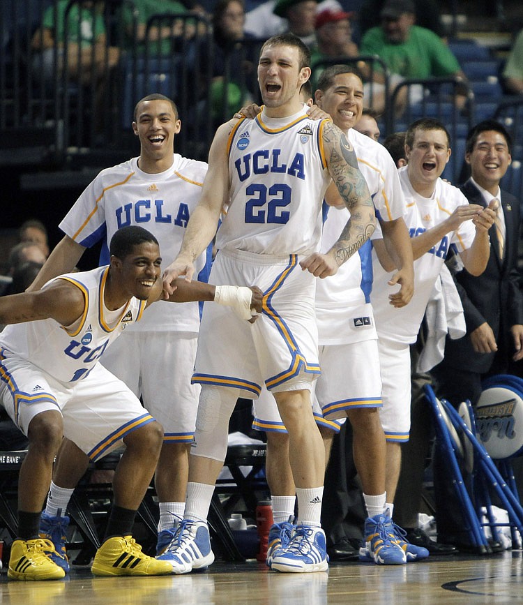 UCLA players including Lazeric Jones, lower left, and Reeves Nelson (22) celebrate from the bench during the second half of a Southeast Regional second-round NCAA tournament college basketball game against Michigan State in Tampa, Fla., Thursday, March 17, 2011. UCLA won 78-76.