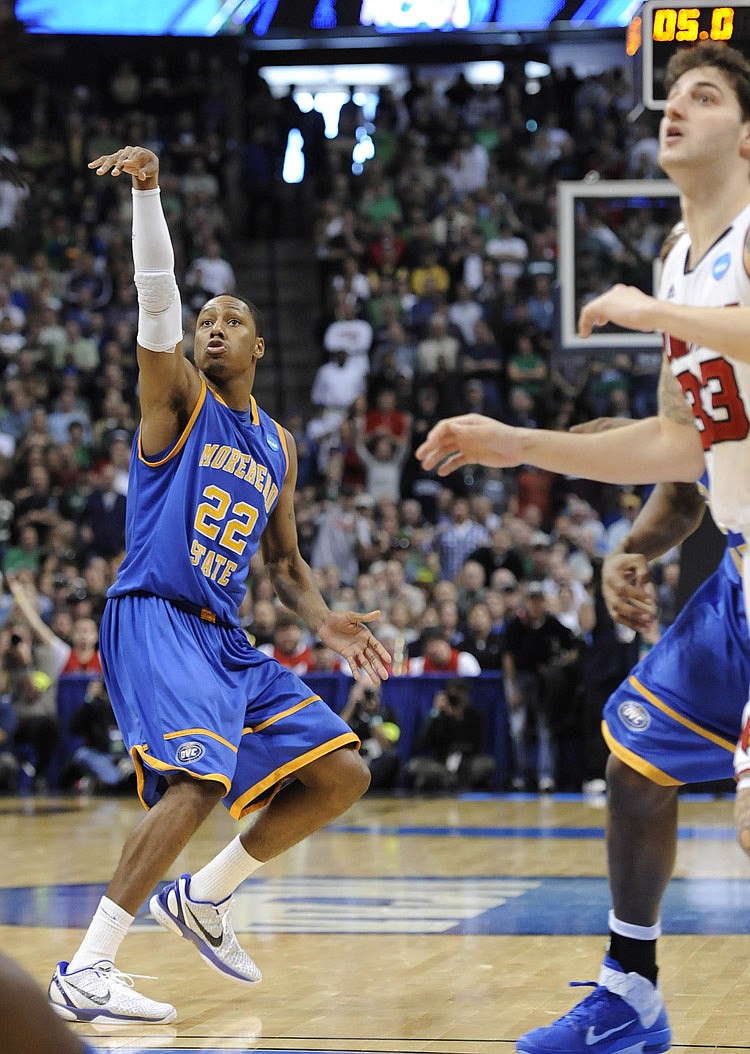 Morehead State guard Demonte Harper (22) follows through on the game-winning three-point basket in the closing seconds of the second half against Louisville in a Southwest regional second round NCAA tournament college basketball game, Thursday, March 17, 2011, in Denver. Morehead State won 62-61.