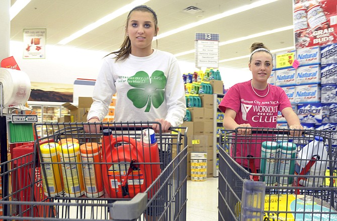 Local eighth-graders Macy Randolph and Darby Brundage shop at Hy-Vee for products to donate to the local animal shelter. The pair are diligently working toward their Girl Scout Silver Award and have created posters and raised money to benefit the Jefferson City Animal Shelter.