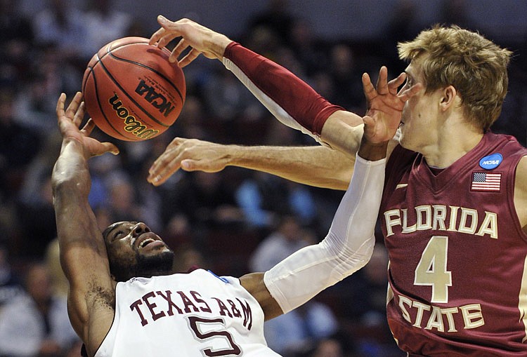 Texas A&M's Dash Harris (5) and Florida State's Deividas Dulkys (4), of Lithuania, fight for a loose ball in the first half of a second-round NCAA Southwest Regional tournament college basketball game in Chicago, Friday, March 18, 2011.