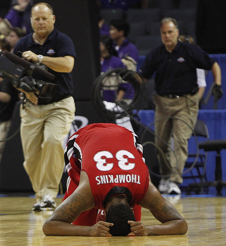Georgia forward Trey Thompkins (33) falls to floor after their game with Washingtonafter the East Regional NCAA tournament second round college basketball game, Saturday, March 19, 2011, in Charlotte, N.C. Washington won 68-65.