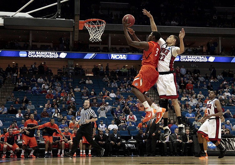 Illinois guard Brandon Paul (3) puts up a shot under pressure from UNLV guard Chace Stanback (22) in the second half of a Southwest Regional NCAA tournament second round college basketball game, Friday, March 18, 2011 in Tulsa, Okla. Illinois won the game 73-62.