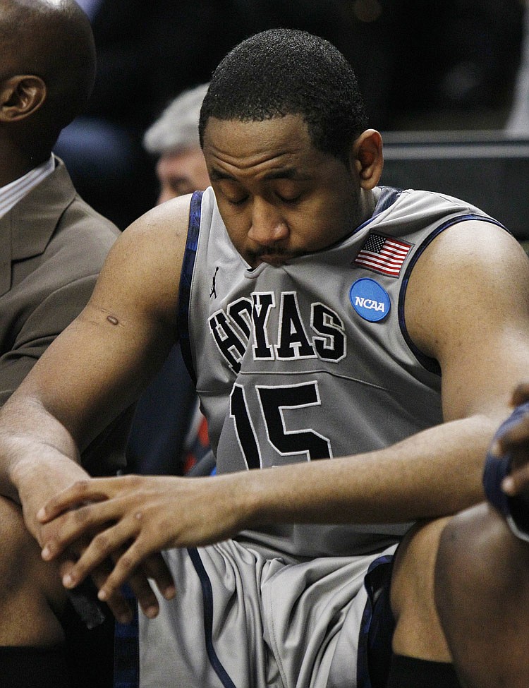 Georgetown's Austin Freeman (15) sits dejected on the bench in the closing moments of Georgetown's 74-56 loss to Virginia Commonwealth in a second-round NCAA Southwest Regional tournament college basketball game in Chicago, Friday, March 18, 2011.