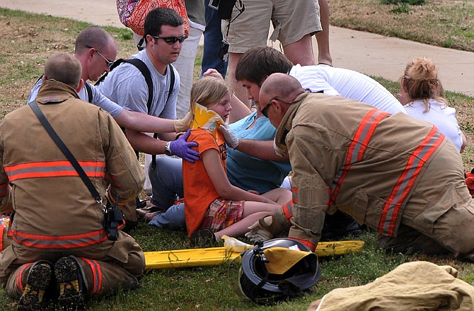Rescue workers attend to an injured girl after a children's train ride at Cleveland Park derailed Saturday in Spartanburg, S.C. Frantic 911 calls released Tuesday offer a glimpse of the frightening scene.