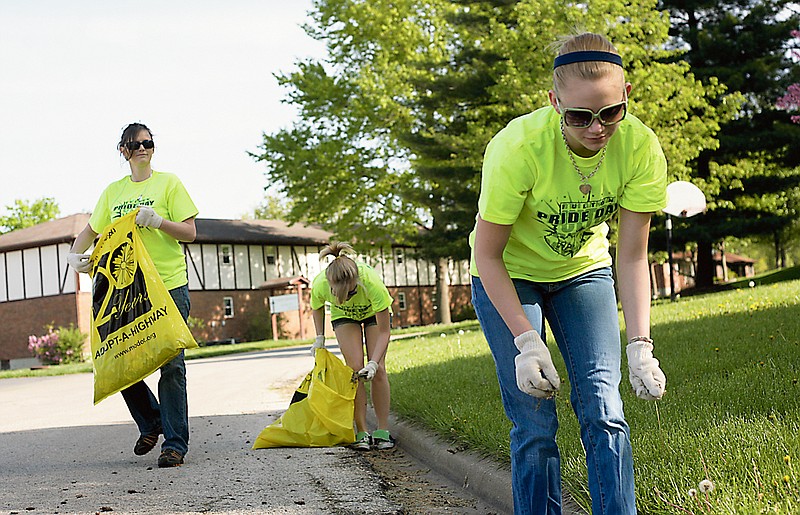 FULTON SUN file photo: (From left) Kandy Johnson, Samantha Surface and Kate Johnson puruse the lawns near Maupin Funeral Home for trash while participating in the City of Fulton's tenth annual Pride Day clean up project last year. Fulton Pride Day was initiated in 2001 by former Mayor Robert Craghead with the intent of making the city cleaner and create a healthier living environment.