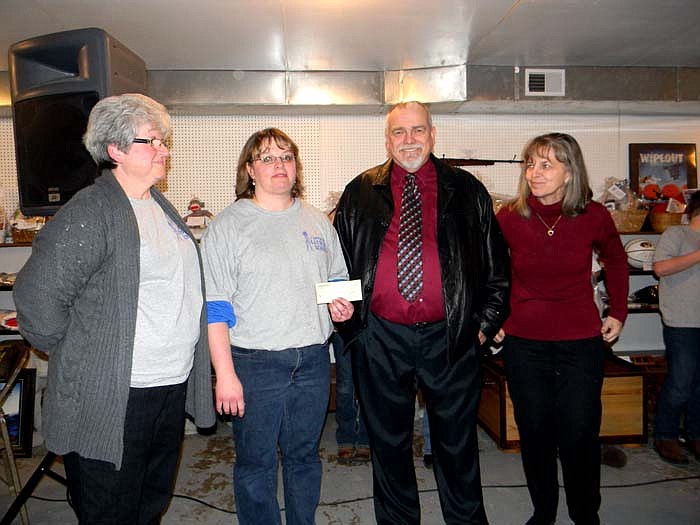 Those present as a check of $7,500 was presented to Latham School on behalf of the Co-Mo Cares Trust at the Latham Ham and Turkey Benefit Dinner held Saturday, March 26 in Centennial Hall at the Moniteau County Fairgrounds, California; from left, are Latham R-V Librarian Eldora Yoder, Latham R-V Administrator Tanya Brown, Co-Mo Cares Trust Chairman Darrel King and Co-Mo Cares Trust Treasurer Tina Potts.