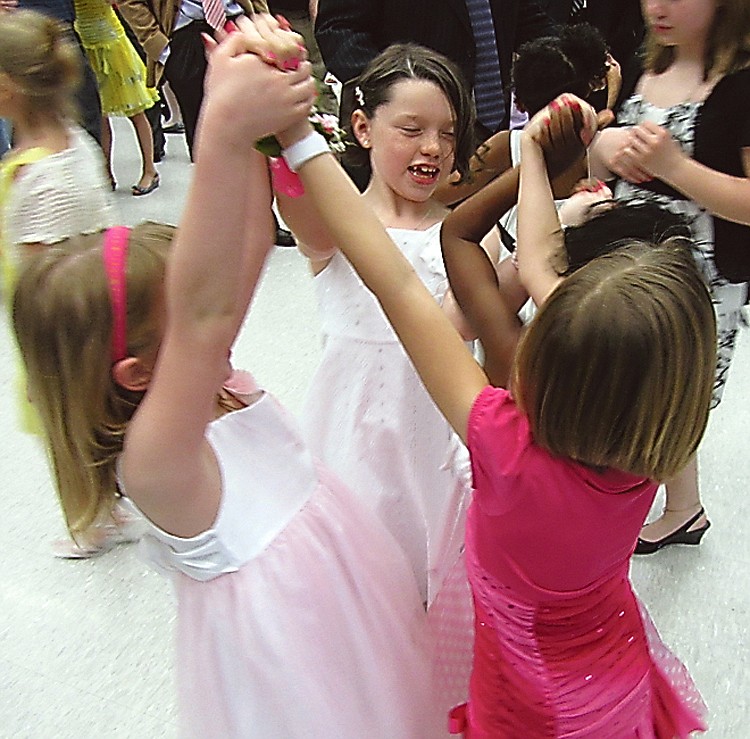 At center, Addison Burns, a Lawson Elementary Schools second-grader, dances with her fellow Lawson students (from left) Chloe Hughey, Laurel Burns and Tianna James at Sunday's Papa and Princess Dance.