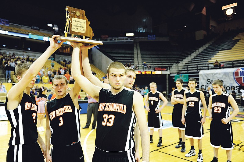 Dak Dillon/FULTON SUN photo: From left, New Bloomfield seniors Aaron Bedsworth, Kolby O'Dowd, Trent Crawford and Daniel Berry hold aloft the Class 2 fourth-place trophy after the Wildcats lost to Wellington-Napoleon 90-67 on March 18 at Mizzou Arena in Columbia. Bedsworth, O'Dowd and Berry were named to the boys' all-district basketball team chosen by mid-Missouri members of the Missouri Sportswriters and Sportscasters Association.