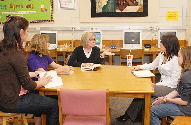 From left, Susan Acree, teacher and founder of the club; Madison White, seventh-grader; Jeannine Toomey, teacher; Teresa Rotter and daughter Taylor Rotter, sixth-grader, meet in the Lewis and Clark Media Center for their monthly Mother/Daughter Book Club. They discussed "The Chosen One" by Carol Lynch Williams.