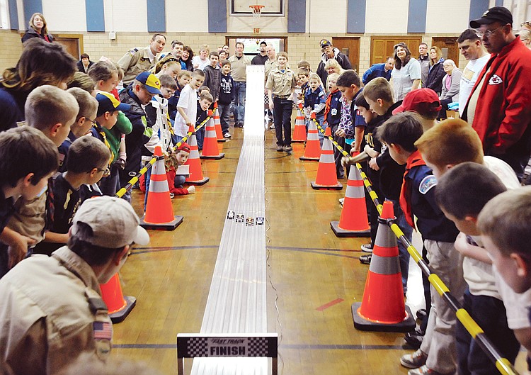 All eyes watch the final race at of the Cub Scout Pack 4's Pinewood Derby at St. Peter Friday. The top three cars would move on to compete at the District Championship at Ike Skelton Training Center. To view this and other photographs, please visit www.newstribune.com/photos.