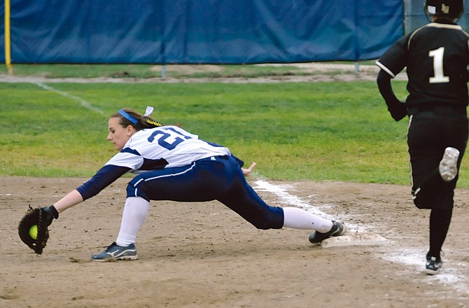 Lincoln first baseman Erin Sommerer stretches to record an out during the second game Wednesday's doubleheader against Lindenwood at Lincoln Field.