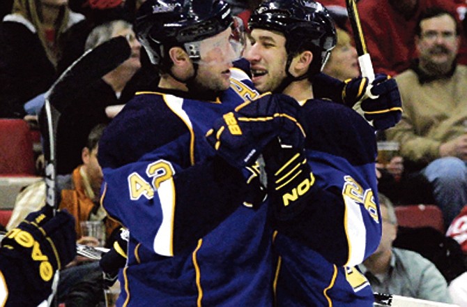 St. Louis Blues' BJ Crombeen, right, celebrates his second-period goal with teammate David Backus in an NHL hockey game against the Detroit Red Wings, Wednesday, March 30, 2011, in Detroit. 