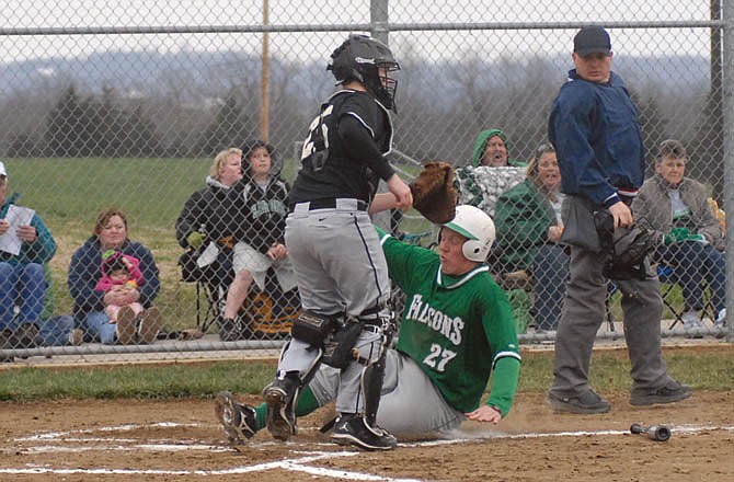 Adam Forck of Blair Oaks slides home for a run around Versailles catcher Michael Harlin during Thursday's game at the Falcon Athletic Complex in Wardsville.