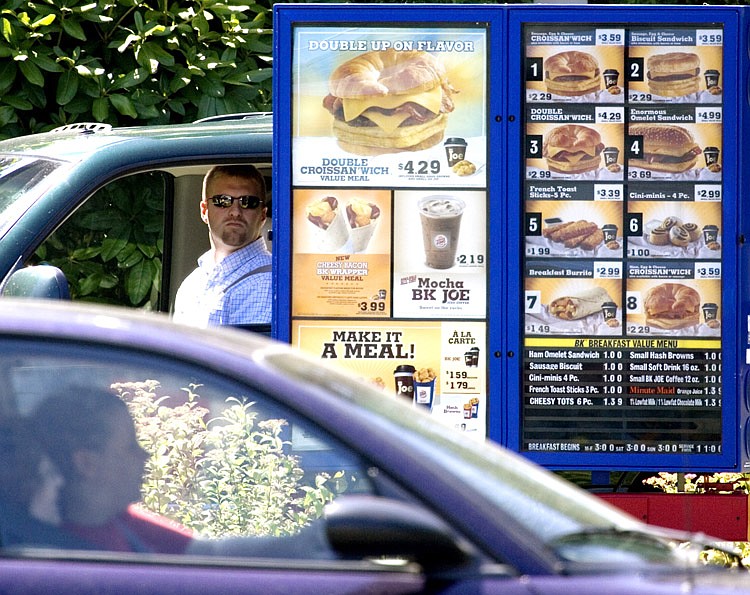FILE - In this July 31, 2008 file photo, customers view the menu in the drive through line at a Burger King in Portland, Ore., Like it or not, many restaurant diners will soon know more about what they are eating under menu labeling requirements proposed Friday by the Food and Drug Administration. The requirements will force chain restaurants with 20 or more locations, along with bakeries, grocery stores, convenience stores and coffee chains, to clearly post the amount of calories in each item on menus, both in restaurants and drive-through lanes. The new rules will also apply to vending machines where calorie information isn't already visible on the package.