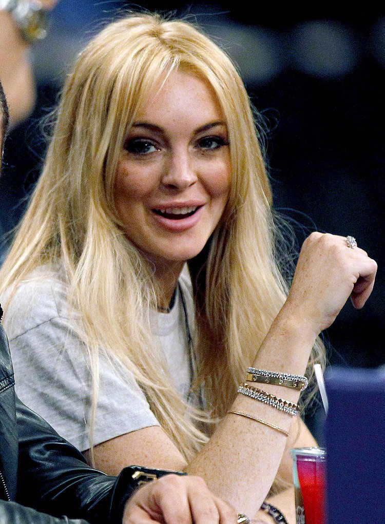 FILE - In this Jan. 9, 2011 file photo, actress Lindsay Lohan is shown at an NBA basketball game between the Los Angeles Laker and the New York Knicks in Los Angeles. Authorities released the 911 call made by Dawn Holland, a Betty Ford Center worker claiming that Lindsay Lohan hit her during a December argument at the facility.