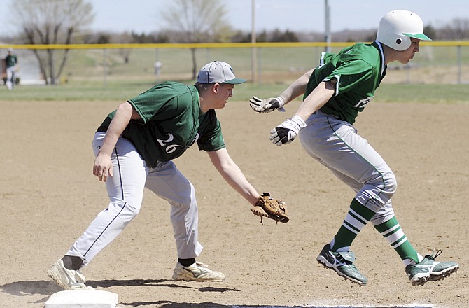 Austin Kempker of Blair Oaks crosses first base after beating a throw to Paul Risher of North Callaway during Saturday afternoon's game at the Falcon Athletic Complex in Wardsville. 