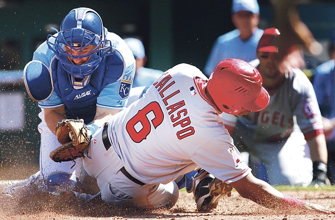 Kansas City Royals catcher Matt Treanor, left, tags out Los Angeles Angels' Alberto Callaspo (6) during the eighth inning of an MLB baseball game in Kansas City, Mo., Saturday, April 2, 2011. The Royals defeated the Angels 5-4. 
