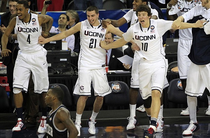 Connecticut players come off the bench after beating Butler 53-41 on Monday night in the national championship game.