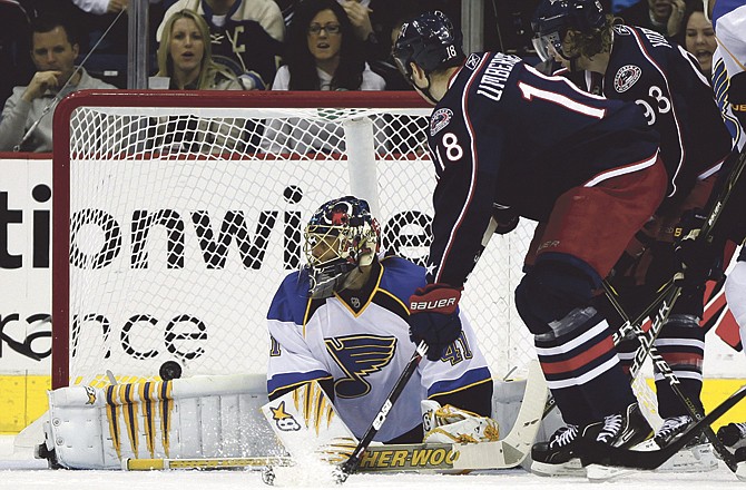 Columbus Blue Jackets' R.J. Umberger (18) scores a goal past St Louis Blues goalie Jaroslav Halak (41), of Slovakia, during the first period of an NHL hockey game Sunday, April 3, 2011, in Columbus, Ohio. Blue Jackets' Jakub Voracek (93), of the Czech Republic, looks on.
