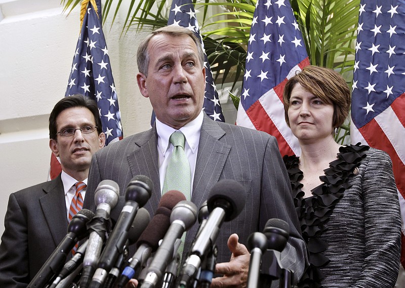 House Speaker John Boehner of Ohio, center, flanked by House Majority Leader Eric Cantor, of Va., left, and Rep. Cathy McMorris Rodgers, R-Wash., talks to reporters on Capitol Hill on Wednesday after meeting to work on a budget deal and avoid a government shutdown. 