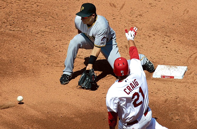 Allen Craig of the Cardinals slides into second while Pirates shortstop Josh Rodriguez waits for the ball during the fourth innng of Wednesday afternoon's game at Busch Stadium.