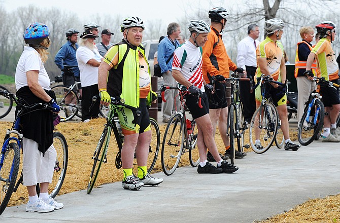A group of bicyclists await the actual ribbon-cutting so they can proceed with their ride up the ramp and across the river Friday. A ceremony was held for the opening of the U.S. 54/63 Missouri River bicycle/pedestrian bridge.