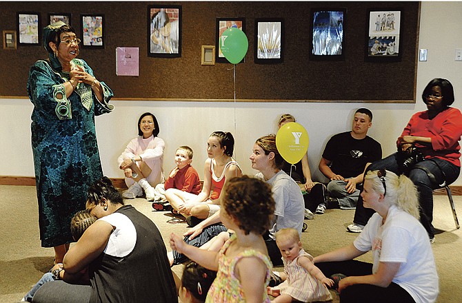 Elizabeth Wilson as "Lizzie the Storyteller" engages children with the Gullah folk talk "The Fox and his Pot" Saturday morning at Missouri River Regional Library in Jefferson City. April 10-16 is The Week of the Young Child. 