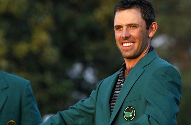 Charl Schwartzel of South Africa shows off his green jacket after winning the Masters golf tournament Sunday, April 10, 2011, in Augusta, Ga.