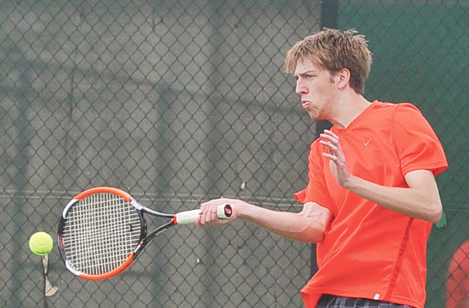 Evan Hasty of the Jays returns a serve during his singles match Monday afternoon against Hickman at Washington Park.