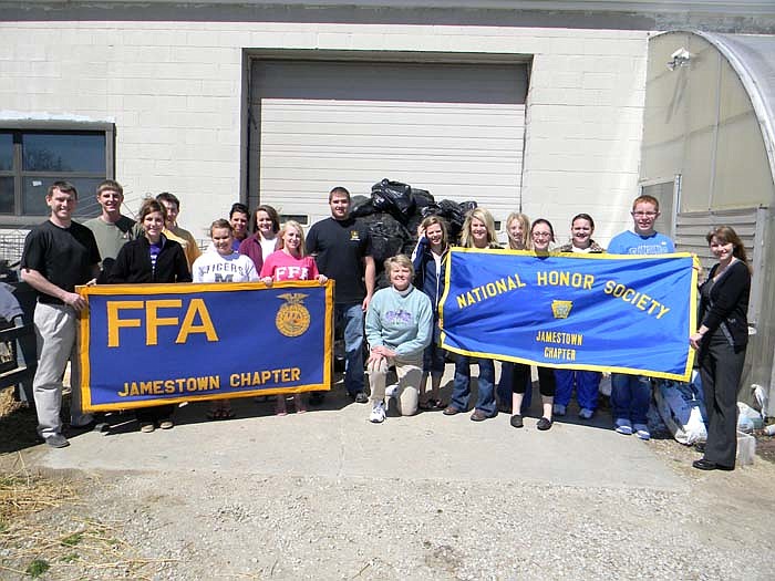 St. Paul's Evangelical Church, Jamestown, member Connie Souden, Jamestown C-I School NHS Sponsor Brenda Selby and FFA Advisor Ben Marshall pose with members of the Jamestown NHS and FFA and the pile of shoes they collected for the Shoeman Project.