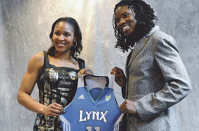 Connecticut's Maya Moore, left, and Xavier's Amber Harris, right, hold up a Minnesota Lynx jersey after being picked by the team in the WNBA basketball draft in Bristol, Conn., Monday, April 11, 2011.