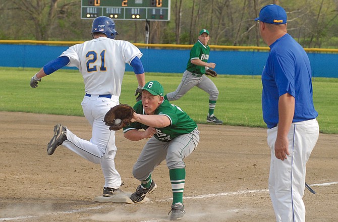 Fatima's Ethan Williams (21) beats the throw to first to reach safely on a dropped third strike during the second inning of Thursday's game in Westphalia. Taking the late throw is Blair Oaks first baseman Adam Forck.