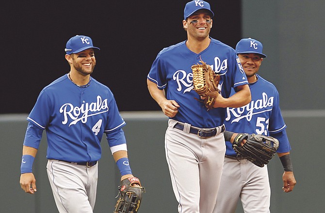 Kansas City Royals left fielder Alex Gordon (4), right fielder Jeff Francoeur, center, and center fielder Melky Cabrera (53) smile as they leave the field after beating in the Minnesota Twins 10-5 during a baseball game in Minneapolis, Wednesday, April 13, 2011. 