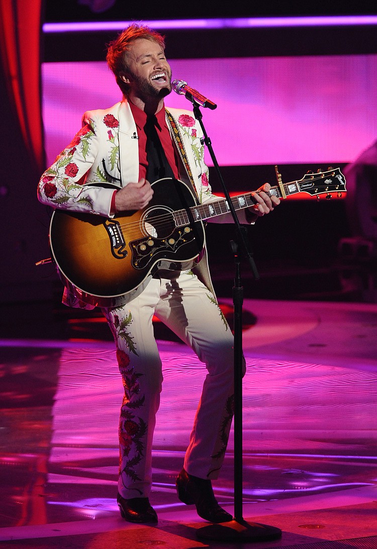 In this Wednesday, March 30, 2011 photo released by Fox, Paul McDonald performs in front of the judges on the singing competition series, "American Idol," in Los Angeles.