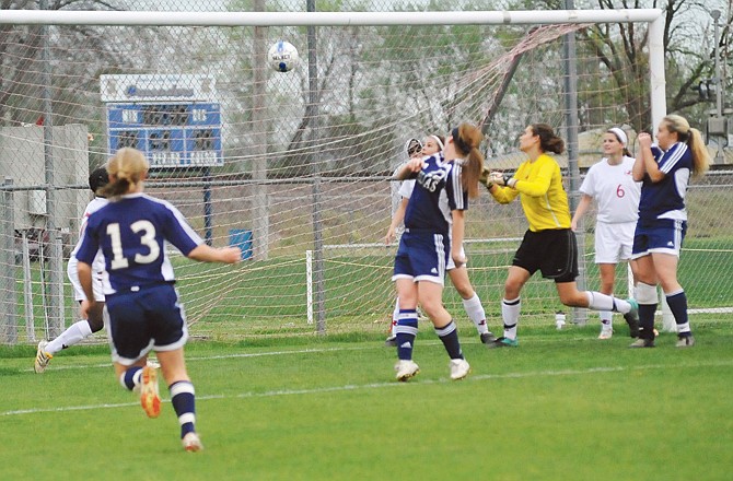 Arielle Chambers of Helias (center) watches her header go into the goal during the first half of Monday's game against Jefferson City in the Capital City Invitational at the 179 Soccer Park. 