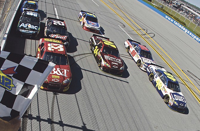 Jimmie Johnson (far right) and Clint Bowyer (33) lead an eight-car group to the finish line Sunday in the Aaron's 499 at Talladega Superspeedway in Talladega, Ala. 