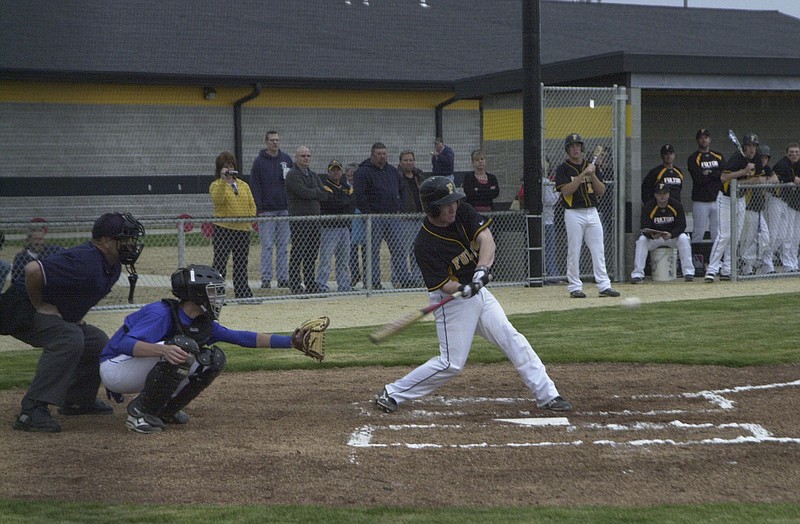 Fulton senior catcher Brandon Hammerstone hits a leadoff double in the first inning the Hornets 4-3 win over the Fatima Comets on Monday afternoon. The game was the first to be played in the Hornets brand new field located directly behind Fulton High School.