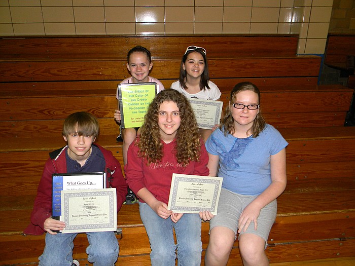 Russellville students who earned blue ribbon (first place, first in category) for their science fair projects at the Science Fair held at Lincoln University March 25; front row, from left, are Beau Whittle (engineering), Stacia Schollmeyer (chemistry) and Megan Briot (chemistry); back row, Libby Mueller (behavioral science) and Isabel Fuller (behavioral science).