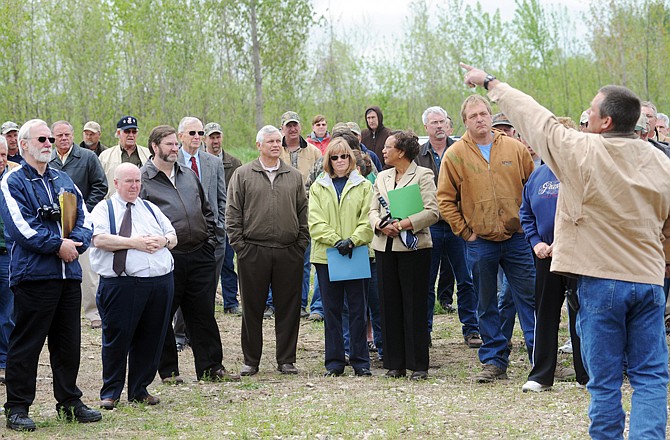 Ringman Craig Gratz, right, takes bids as Lincoln University's Neiderhelman Farm property sells at auction Wednesday along Missouri 94.