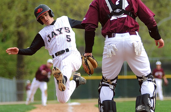 Connor Hager of the Jays gets ready to slide as he scores a run during the second inning of Wednesday's game against the Rolla Bulldogs at Vivion Field.