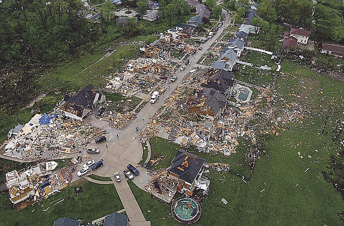 In this aerial photograph, debris is strewn about a neighborhood Saturday, April 23, 2011, in Bridgeton, Mo., following a Friday-evening tornado in the area. St. Louis' main airport was closed for business Saturday while crews cleaned up after a tornado tore through a terminal, causing several injuries and sending people scurrying for shelter as plated glass shattered around them. (AP Photo/Jeff Roberson) 