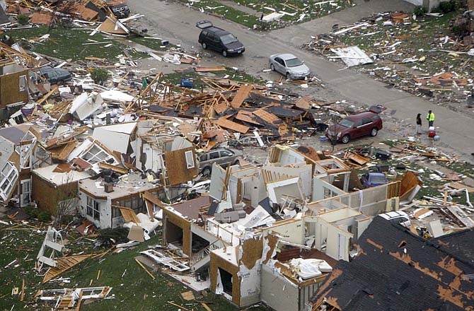In this aerial photograph, debris is strewn about a neighborhood Saturday, April 23, 2011, in Bridgeton, Mo., following a Friday-evening tornado in the area. A severe storm that struck the St. Louis area left homes flattened in suburbs around the main airport. 